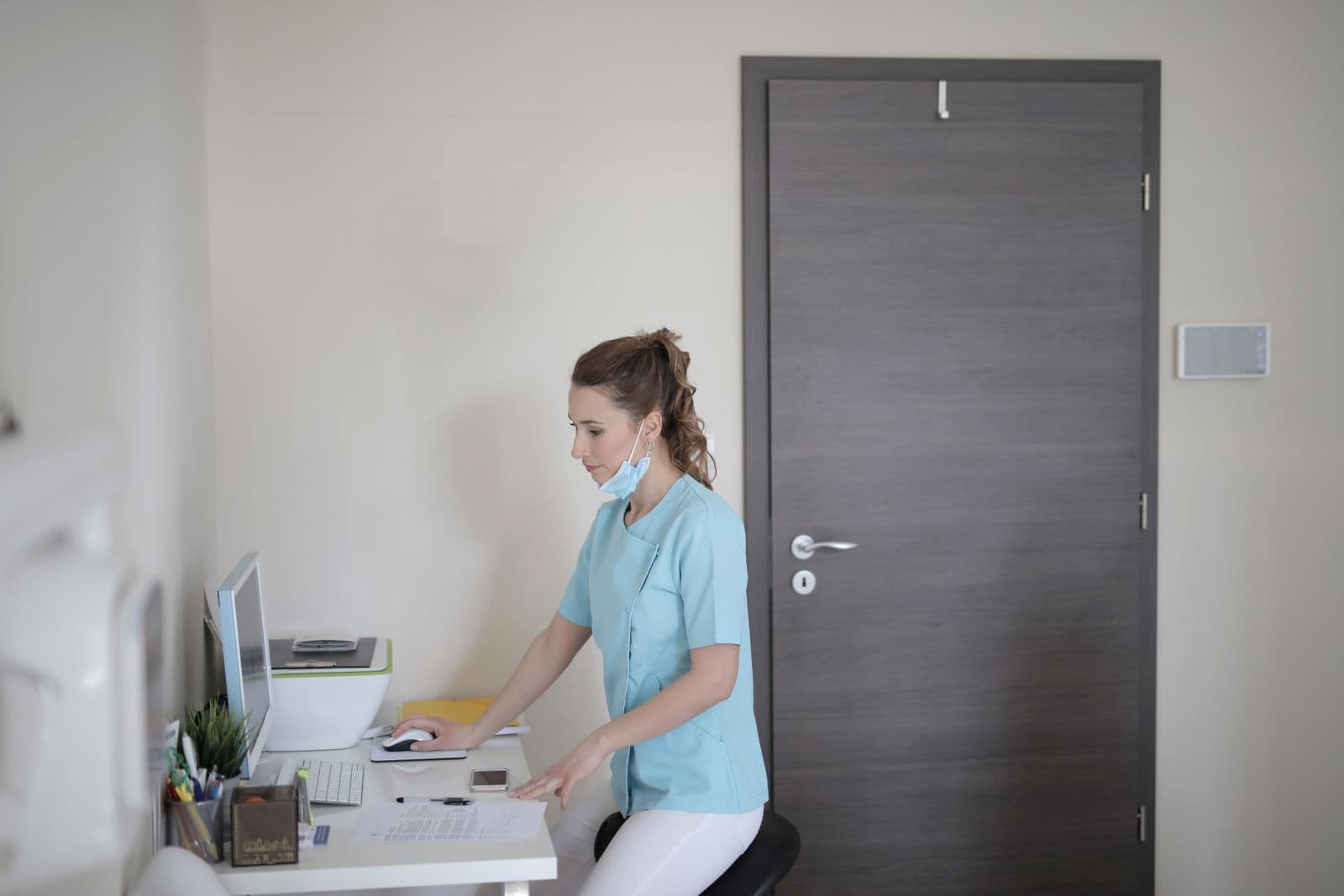 Healthcare professional using a computer workstation in a clinic